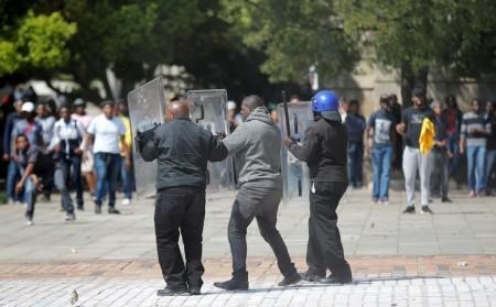 Students throw stones during clashes with security at Johannesburg"s University of the Witwatersrand as countrywide protests demanding free tertiary education entered a third week, South Africa, September 20, 2016.